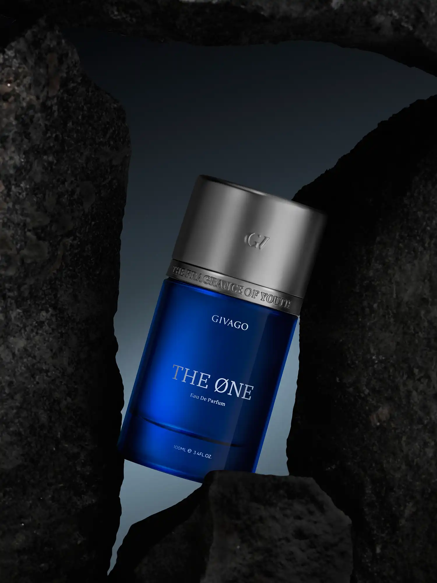Givago The One cobalt-blue perfume bottle tilted between dark stone slabs